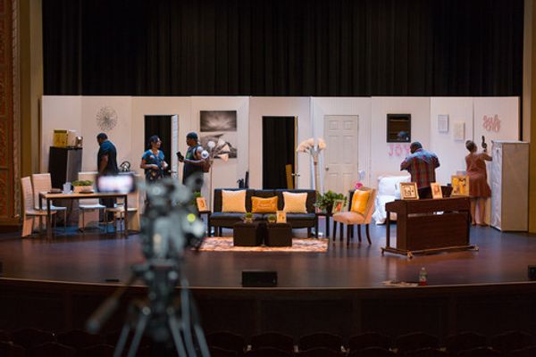 Writer, producer, director and set decorator Ceola J., is finishing decorating the set before filming. On stage also is music producer Dre Griffin checking the sound before filming and set builder, Bishop Marcel Robinson putting the finishing touches on the set. 4