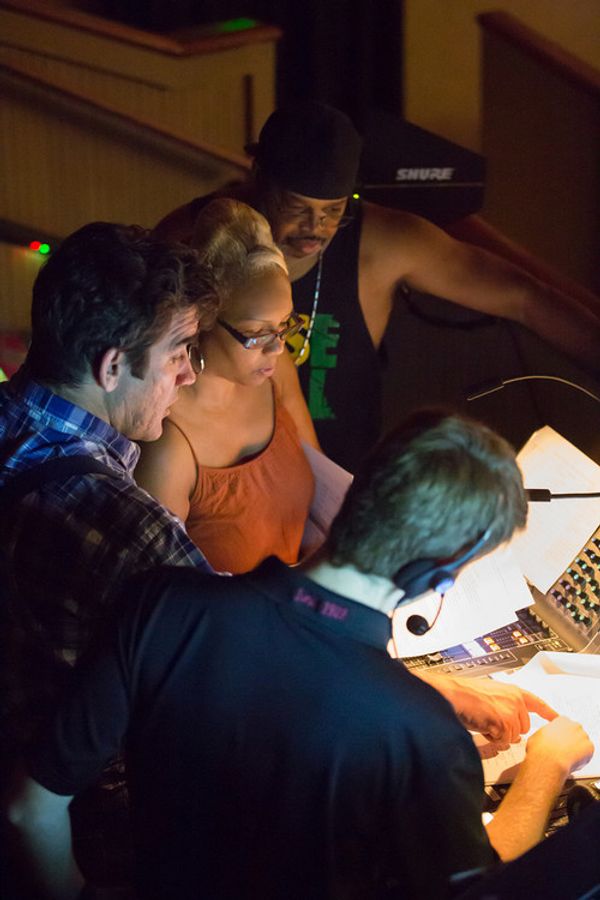 Writer, producer, and director Ceola J. and theatre director Joel Roster, and music composer Dre Griffin with theatre sound technician review script during filming. 5