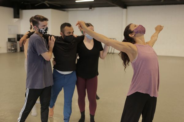 In-studio rehearsal photo of sjDANCEco Co-Artistic Director Maria Basile (in pink shirt) demonstrating movement from Yield to her dancers. Dancers (left to right) are: Ryan Tucker, Kevin Gaytan and Kyleigh Carlson.  Photo by Tom Hassing courtesy of sjDANCEco. 1