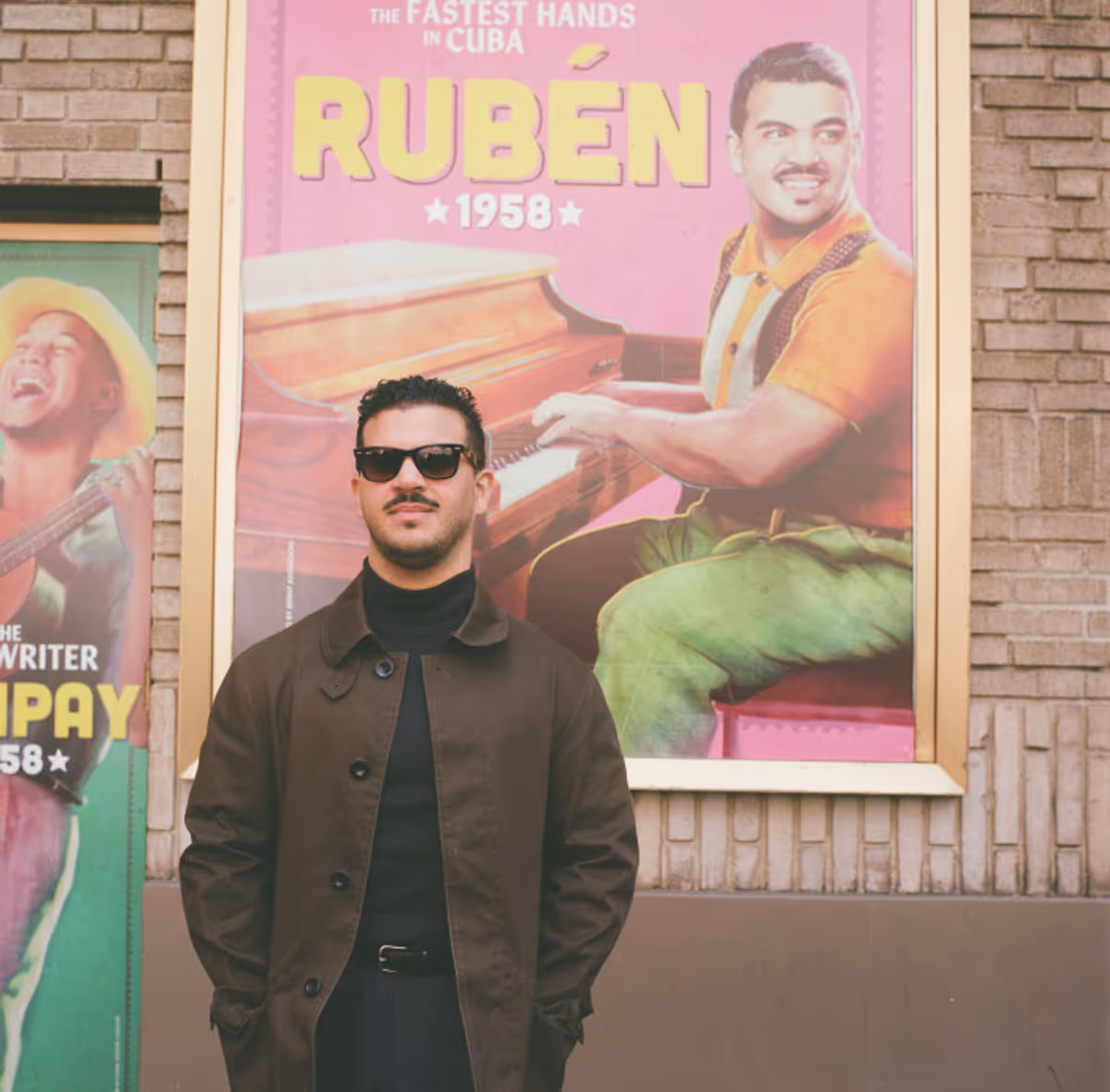 Jesus Pupo beside the Young Ruben character poster outside the Gerald Schoenfeld… Photo