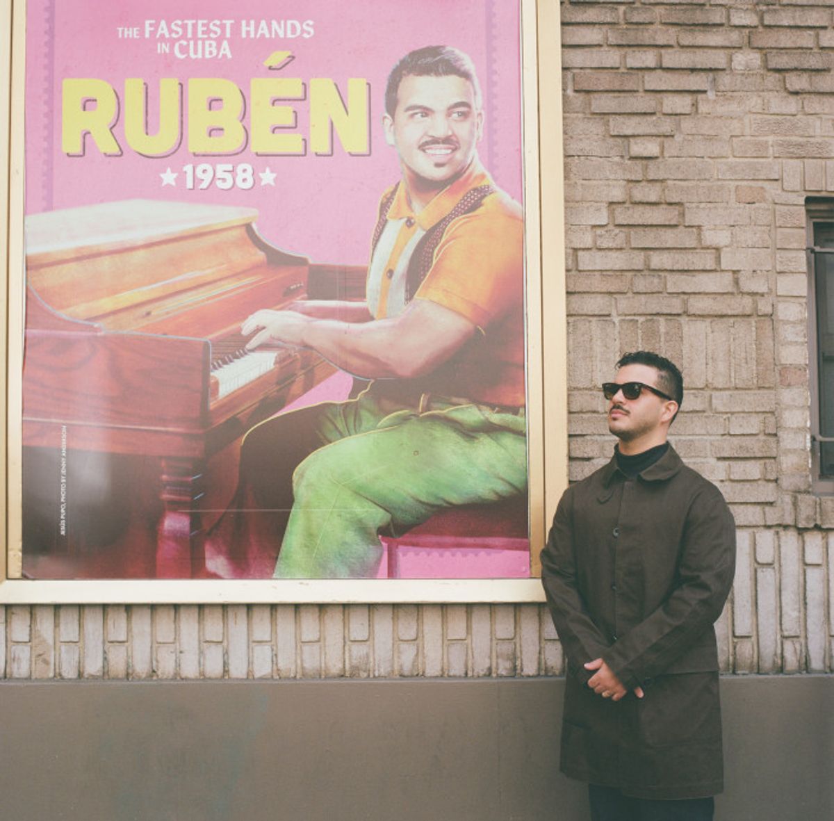Jesus Pupo beside the Young Ruben character poster outside the Gerald Schoenfeld… Photo