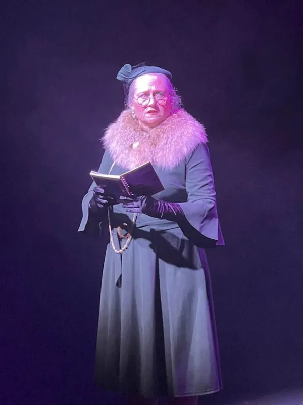 Here, the reporter Adela has the latest news about the Lindbergh baby kidnapping. Pictured: Shawn Witcher as Adela.  5