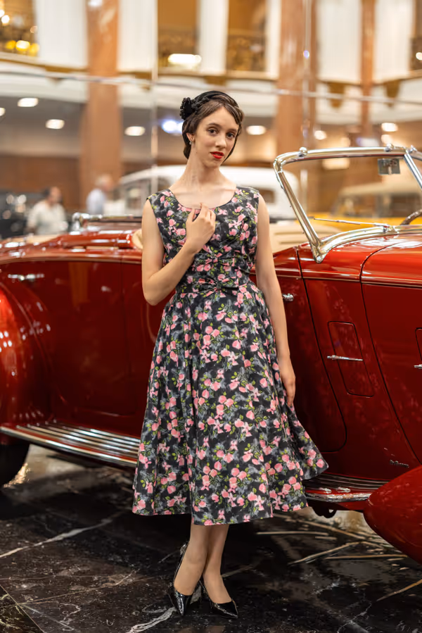 Rebekah Brannan as Betty Shaeffer by a classic car. 1
