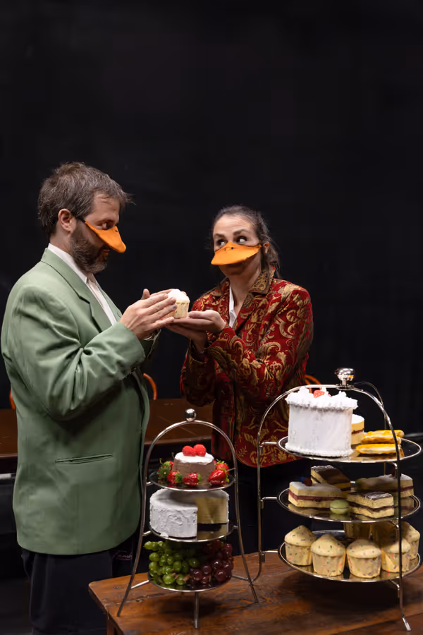 King Leopold II (Allison McCall, r) offers some cake to Mr. Duck (Nate Speckman) in Heart of Duckness by A.J. Ditty. Photo by Hannah Daly Ellsworth. 4
