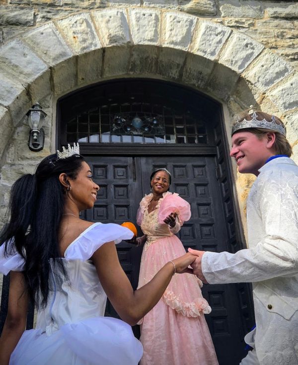 Ella (Sierra Basilio), her Fairy Godmother (Liane Williams), and Prince Topher (Dylan Flaig) enter the Givins Castle in Beverly 1