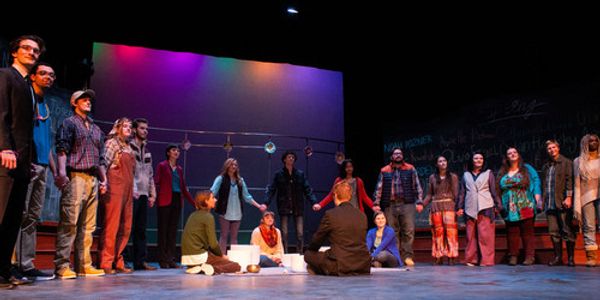 Cast stands holding hands, representing the town on Newtown and their strength. 1