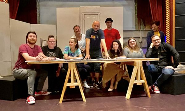 Cast of Godspell at Gaslight Baker Theatre
[From Left to Right: Doug DeGirolamo, Rebecca Smootz, Allison Engel, Tysha Calhoun, David Kelly, Chris Schaible, Ella McCarthy, Laurel Neuhaus, Christopher Saenz, and Taylor Luke (seated)] 1