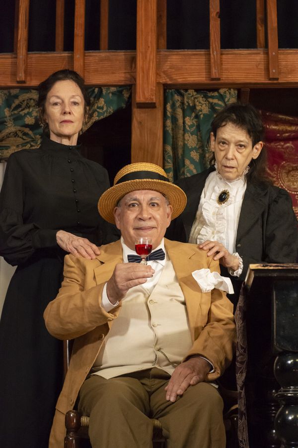 The Brewster Sisters (Margaret Trotter and Judith Shakespeare) offer a guest (Martin Revere) their elderberry wine. 1