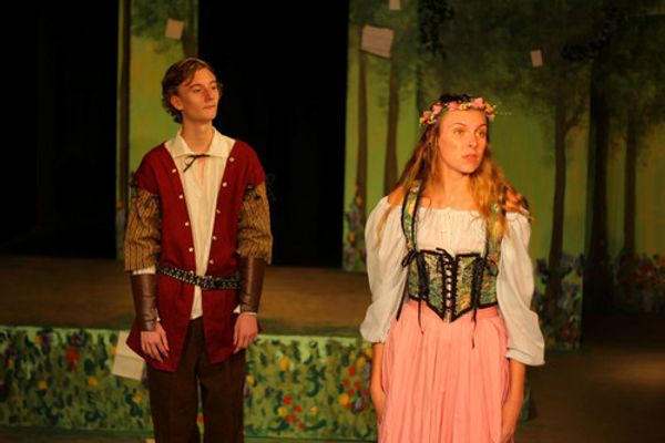 Even a fool like Touchstone (Ken Knight) can find love in the forest with Audrey (Andrea Stradling) as Jaques (Jonah Goger) eavesdrops. 3