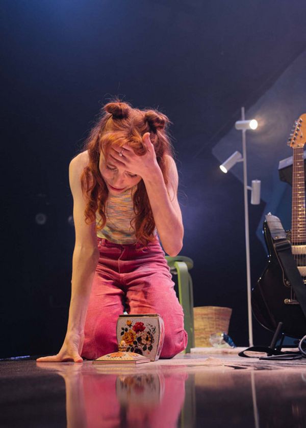 Ally Morgan sits on a raised platform surrounded by ecclectic furniture and her instruments. Image by Cameron Grant, Parenthesy 4
