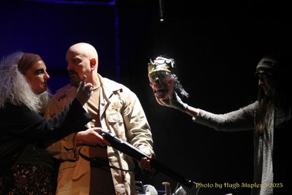 Macbeth converses with the two witches. 1