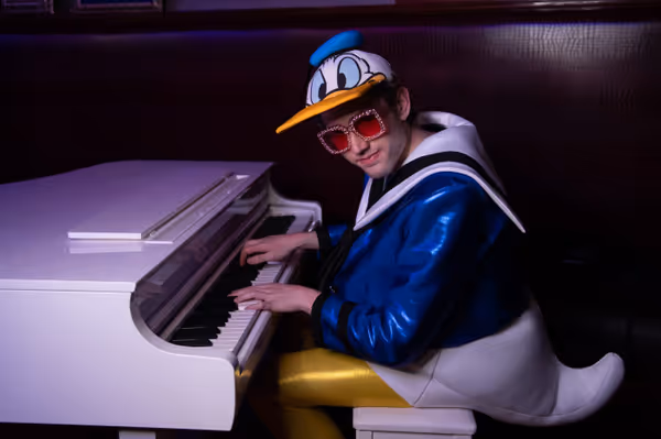 Rock Never Dies Elton plays the piano in famous duck costume 4