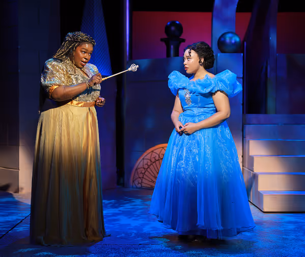 Her Fairy Godmother (Chanel Edwards-Frederick), left, warns Cinderella (Grace Ellis Solomon) to leave the Prince's ball by midnight in Rodgers & Hammerstein's Cinderella, now on stage through July 12. 2