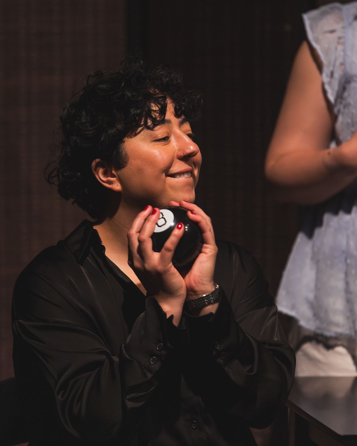 Melanie Santos Cordero as Callie consults a Magic 8 Ball in Stop Kiss. Photo by MCP Photo. Melanie Santos Cordero as Callie consults a Magic 8 Ball in Stop Kiss. Photo by MCP Photo.