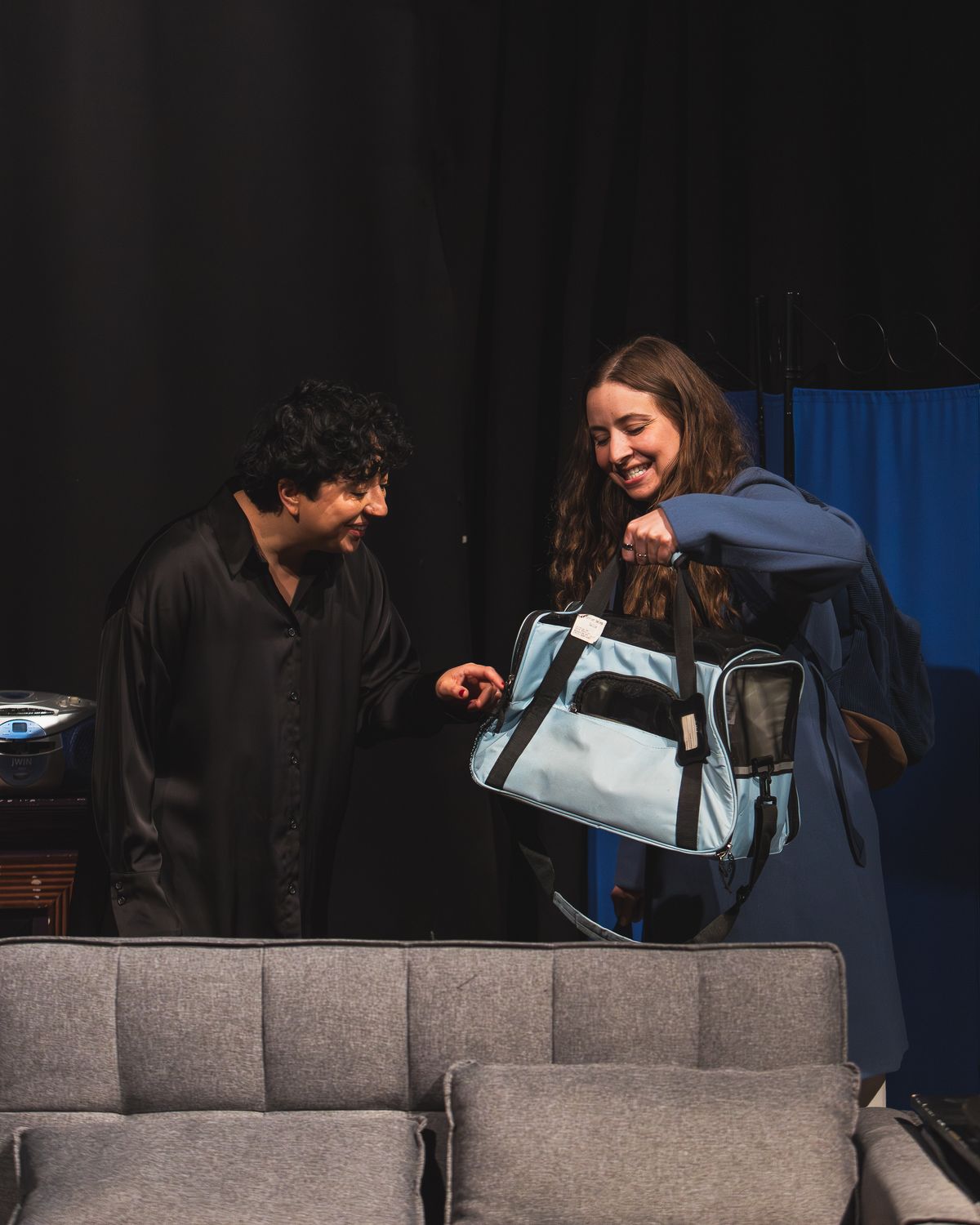 Melanie Santos Cordero as Callie and Bridgette Dove as Sarah in Scene 1 of Stop Kiss, holding a cat carrier. Photo by MCP Photo.