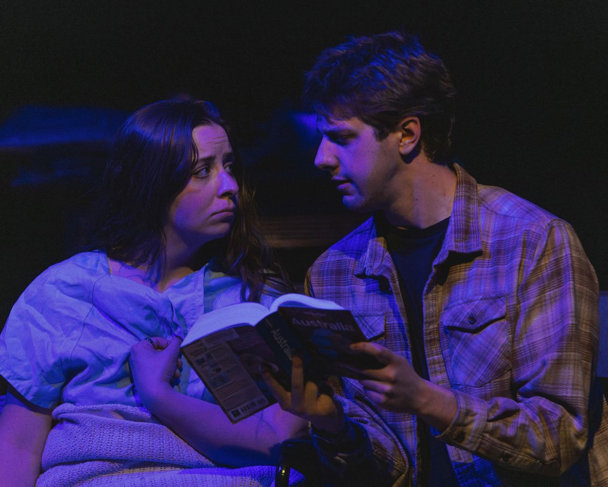 Spencer Hazen as Peter reads to Bridgette Dove as Sarah in her wheelchair in Stop Kiss. Photo by MCP Photo. Spencer Hazen as Peter reads to Bridgette Dove as Sarah in her wheelchair in Stop Kiss. Photo by MCP Photo.