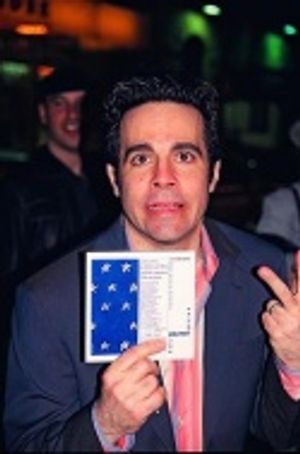 Mario holding up a gift, an original playbill from the Off-Broadway Production  Photo