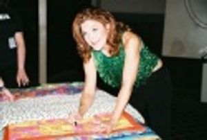 Victoria Clark signing a quilt to be auctioned off for the victims of Hurricane Katri Photo
