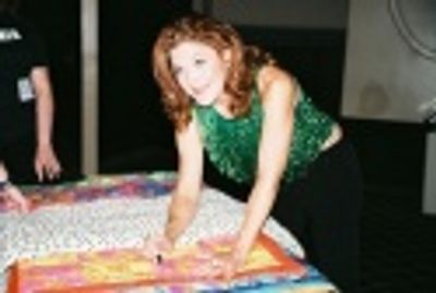 Victoria Clark signing a quilt to be auctioned off for the victims of Hurricane Katri Photo