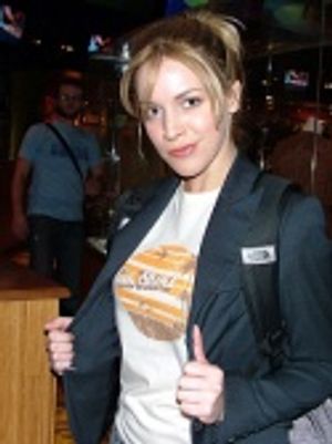 Sara Chase shows off her tan shirt Photo