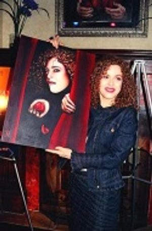 ...and showing the painting to those on the left  Photo