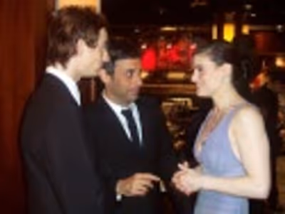 Andy Pellick and Joe Mantello talking to Idina Menzel  Photo
