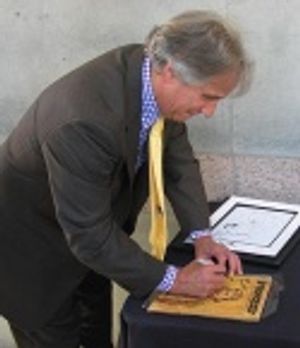 Henry Winkler autographing 'Fonzie' memorabilia for the charity tables Photo
