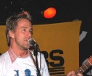 Greg Reuter singing an original song paying homage to TV stars of the 1980's  Photo