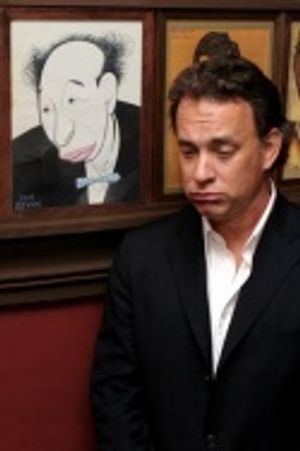 Tom Hanks poses in front of a caricature Photo