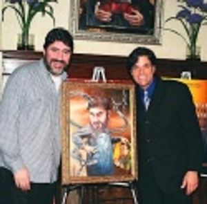 A beaming Alfred posing with his painting along with Dale Badway Photo
