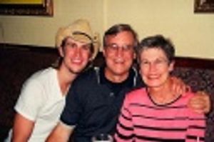 Gavin posing with his parents Photo