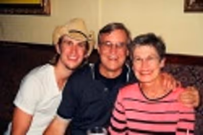 Gavin posing with his parents Photo