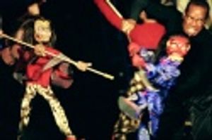 Shanon Stoeke and Kevyn Morrow manipulate the Monkey King and Demon puppets in a batt Photo