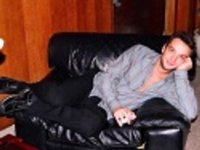 Euan enjoys a few moments lounging at the party after having sung
a very rousing "Wh Photo