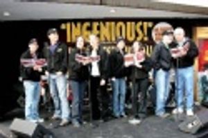 Drowsy Chaperone cast members treat Times Square  to a holiday carol outside the Marr Photo