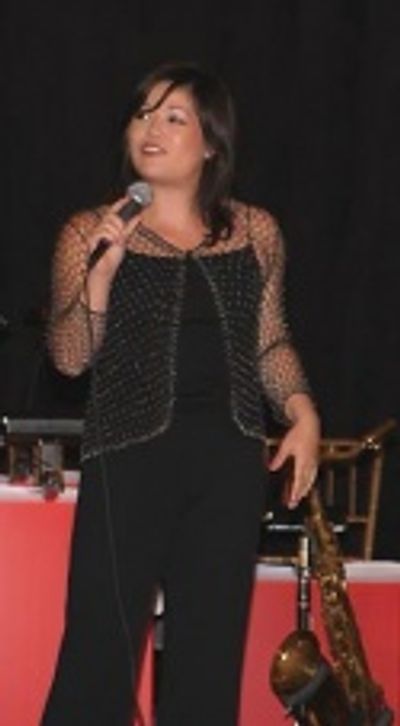 Erin Quill sings "The More You Ruv Someone" from the Tony Award-winning Best Musical, Photo