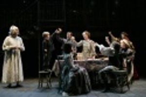 Wynn Harmon as Scrooge observes the happy Cratchit family, with Luke Sauer as Tiny Ti Photo