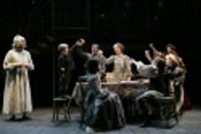 Wynn Harmon as Scrooge observes the happy Cratchit family, with Luke Sauer as Tiny Ti Photo