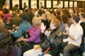 John Leguizamo enters a capacity filled room as the overflow crowd waits outside Photo