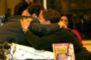 John Leguizamo hugs a fan, who has presented him with flowers Photo