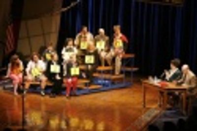 (At desk) Lisa Howard and Greg Stuhr with cast and spellers, including (from bottom r Photo