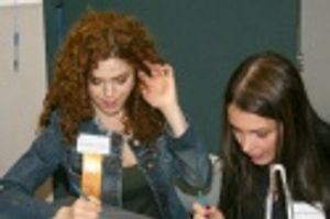 Bernadette Peters and Angie Martinez tabulating scores to determine a winner Photo