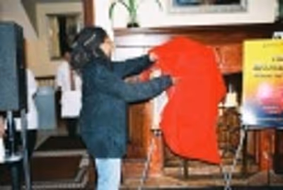 Whoopi unveiling her painting for the crowd Photo