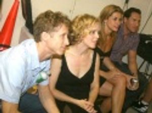 Cast members, including Nancy Anderson, watching the backstage monitor Photo