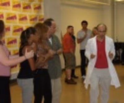 Stephen DeRosa (in white coat) and ensemble Photo