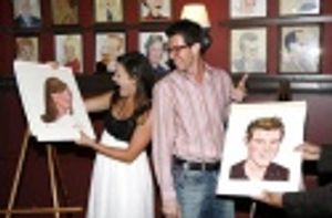 Ashley Brown and Gavin Lee admire their portraits Photo