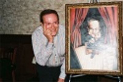 Jerry Herman posing with his painting for Tony DiNapoli's Broadway Wall of Fame, whic Photo