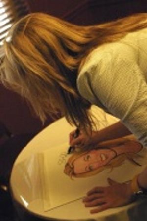 Sherie signs her caricature Photo