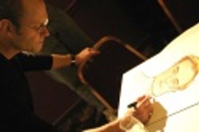 David singing his portrait before its hung on the wall... Photo