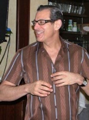 The crowd chants "Take it off!" and Jeff does
a faux striptease before taking the un Photo